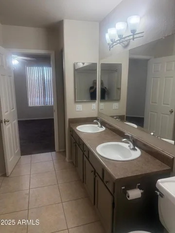 a bathroom with a sink double vanity and a mirror