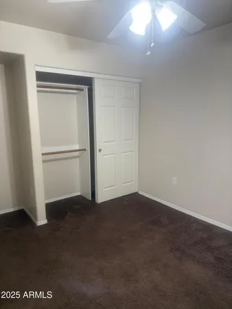 an empty room with closet area