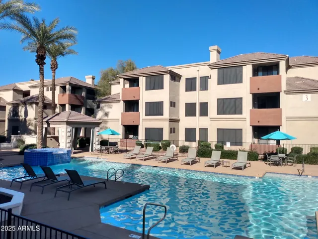 a front view of building with yard and outdoor seating