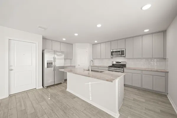 a kitchen with stainless steel appliances granite countertop a white stove top oven and white cabinets