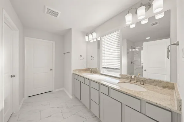 a bathroom with a shower and a glass door