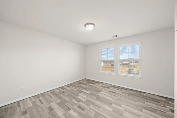 a view of an empty room and wooden floor