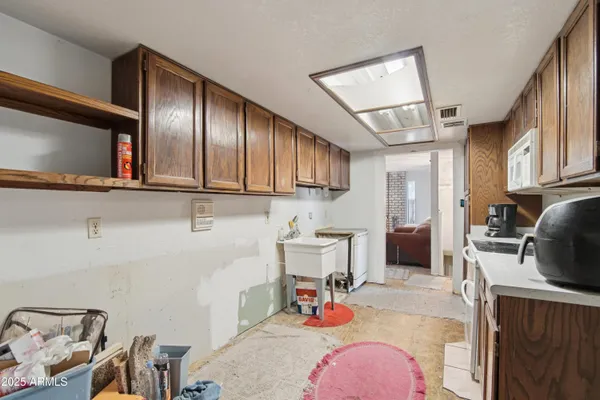 a kitchen with a sink stove and cabinets