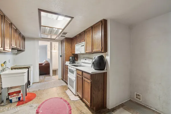 a view of an empty room with window and bathroom