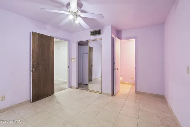 a living room with a bed furniture and a flat screen tv