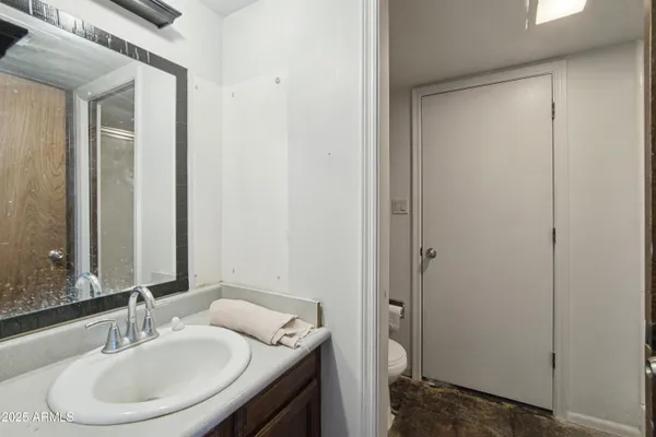 a spacious bedroom with a bed and wooden floor