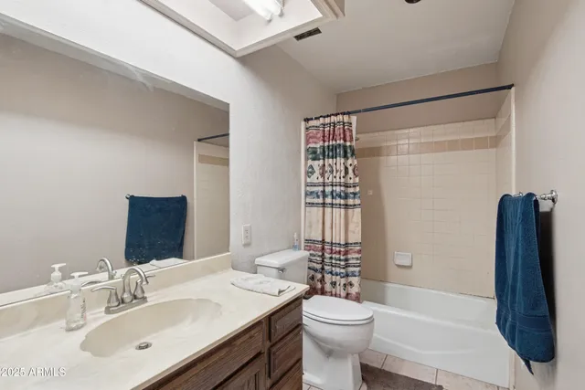 a view of empty room with a fireplace and cabinet