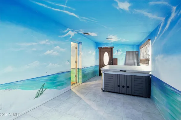 an empty room with a fireplace and entryway