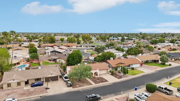 an aerial view of residential houses with outdoor space