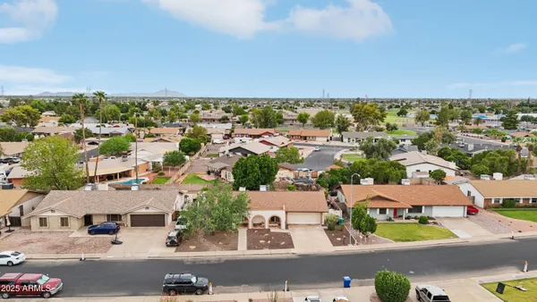 an aerial view of residential houses with outdoor space