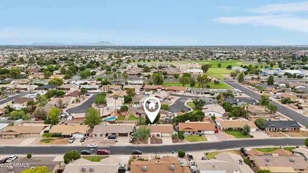 an aerial view of a house with a yard