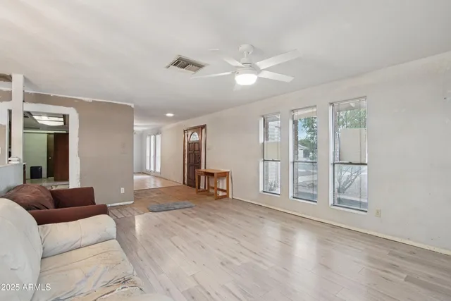 a spacious bedroom with a large bed and a large window