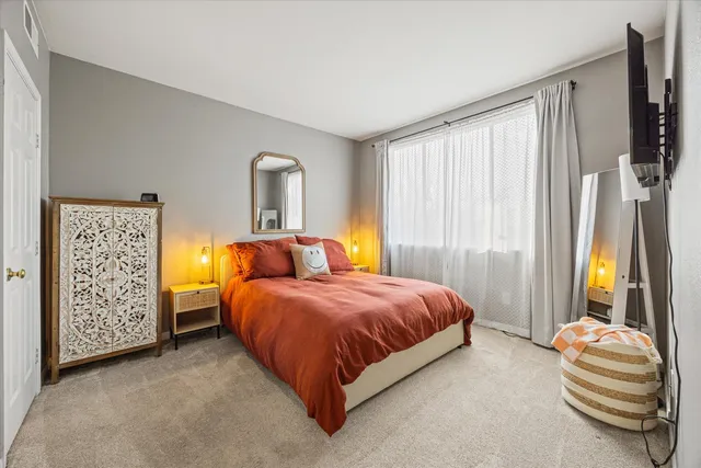 a spacious bedroom with a bed and a window