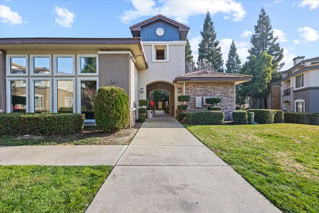 a front view of a house with a garden