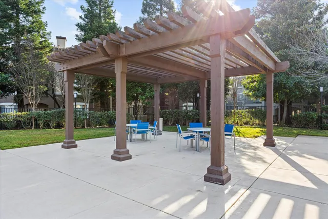 a view of a patio with table and chairs under an umbrella