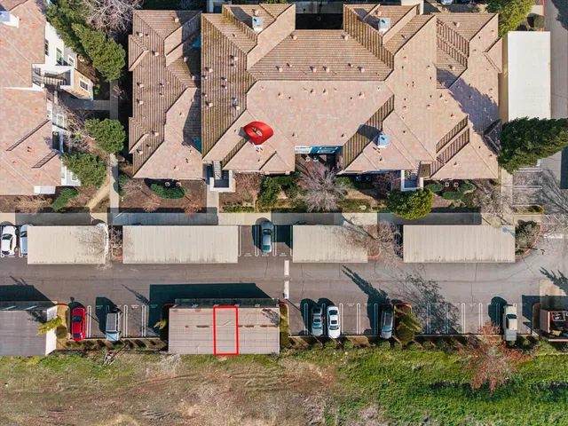 an aerial view of a house with a yard