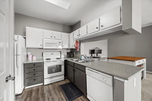 a kitchen with a white cabinets and white appliances