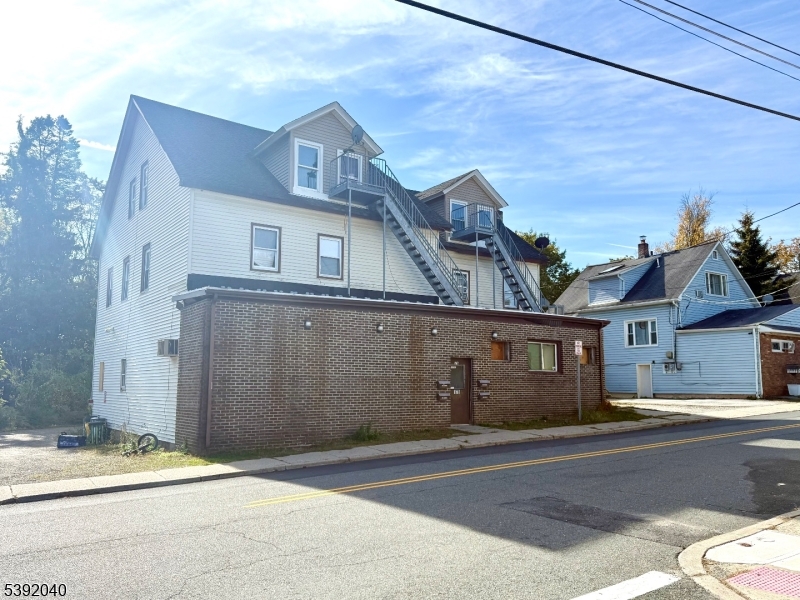 a front view of a house with a road
