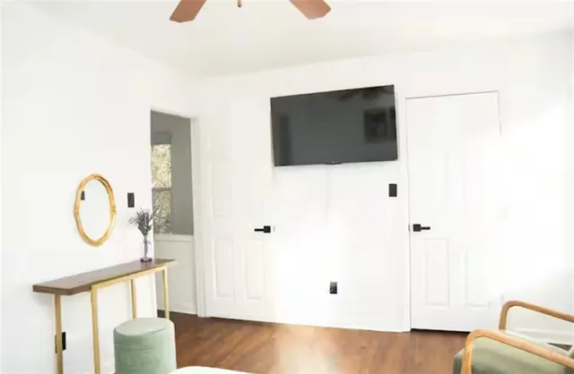 a bed sitting in a bedroom and lamp next to a window