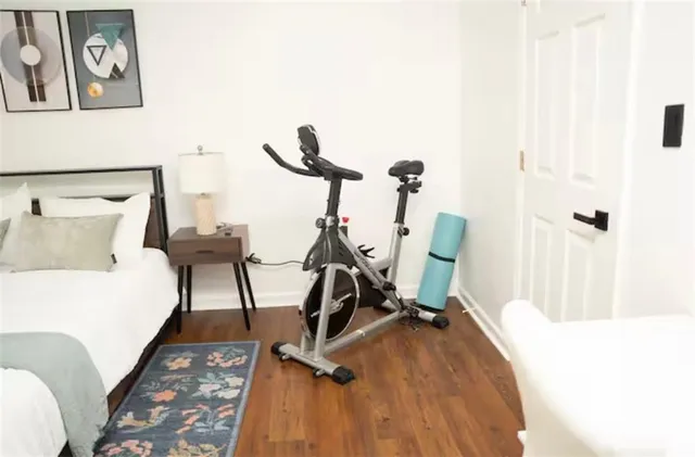 a view of a workspace with furniture and wooden floor