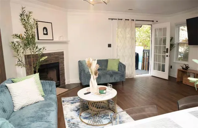 a living room with furniture a dining table and a fireplace