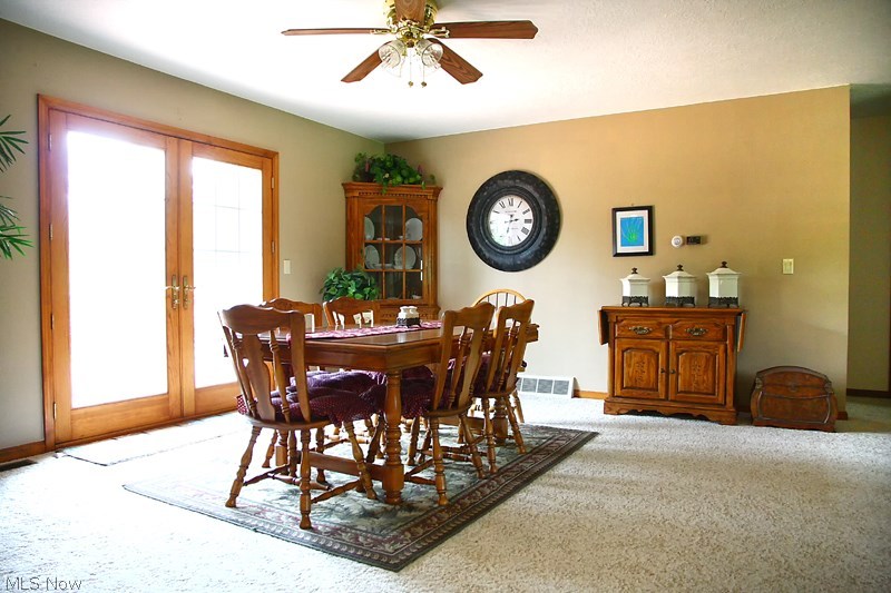 Massive dining area adjacent to living and kitchen area.  Access to private deck through french doors.