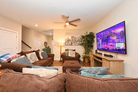 a living room with furniture and a ceiling fan