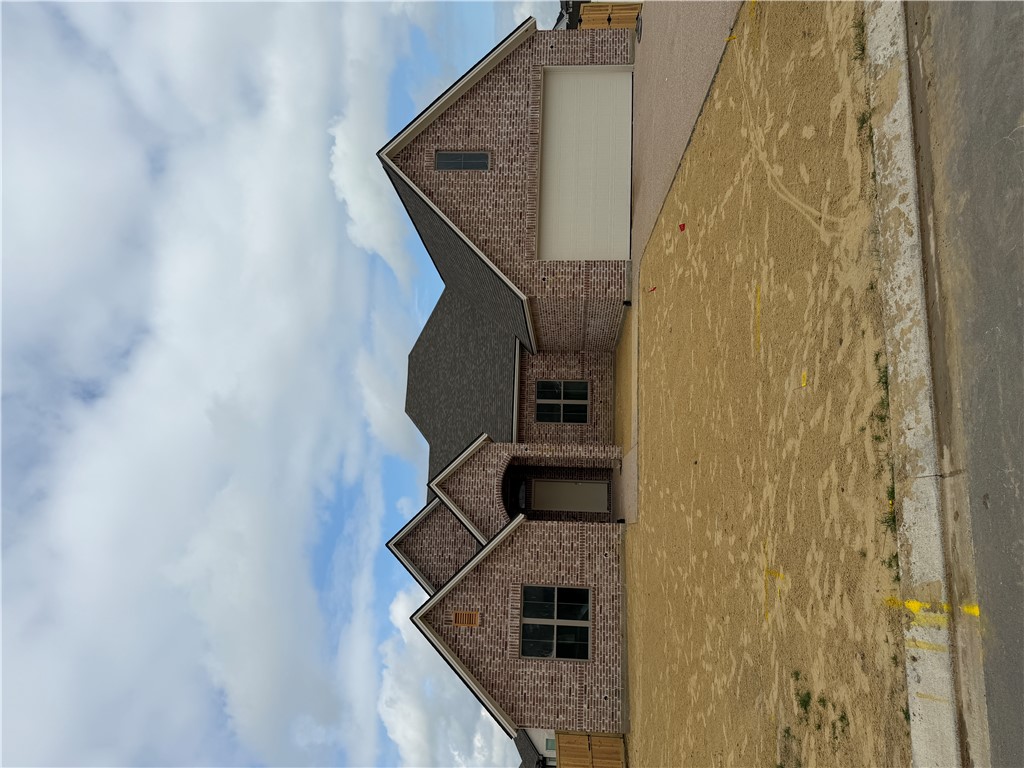 5107 Greenstone Way Bryan, TX 77802 - Photo 3 of 22 a front view of a house with a yard and garage
