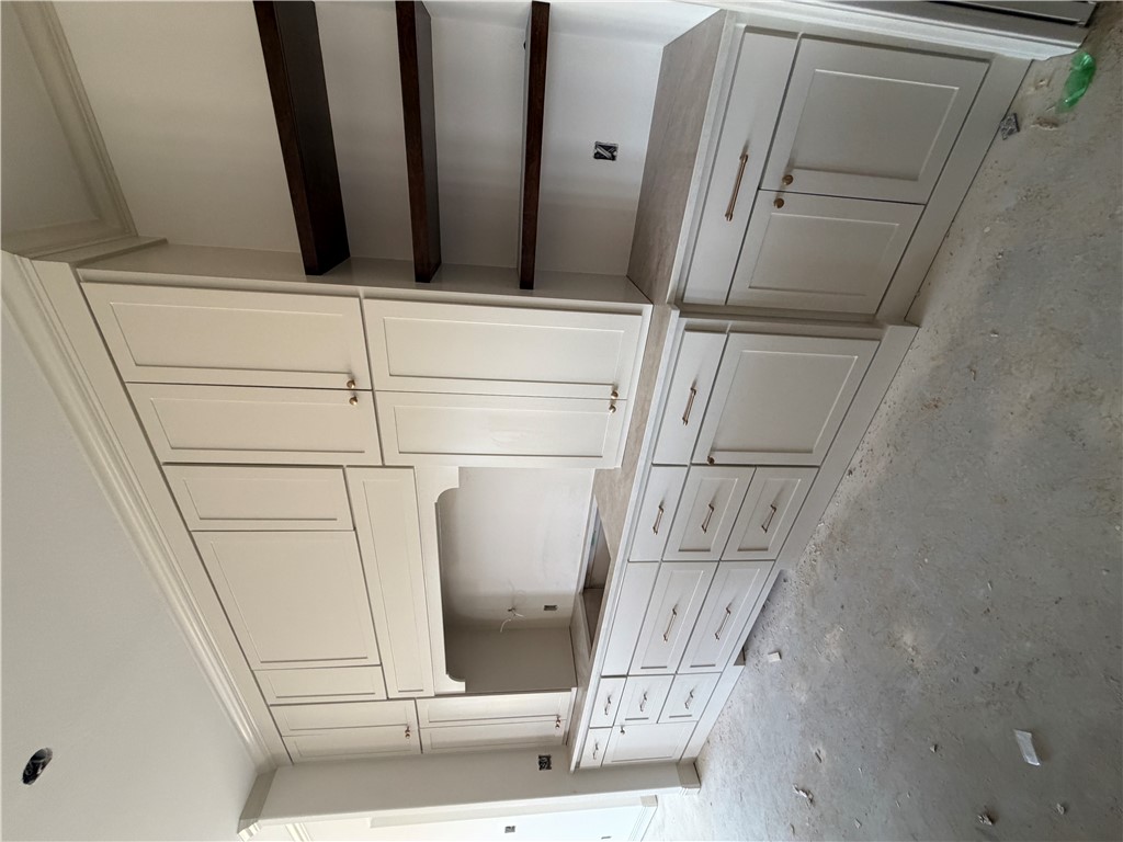 5107 Greenstone Way Bryan, TX 77802 - Photo 6 of 22 a kitchen with white cabinets and sink