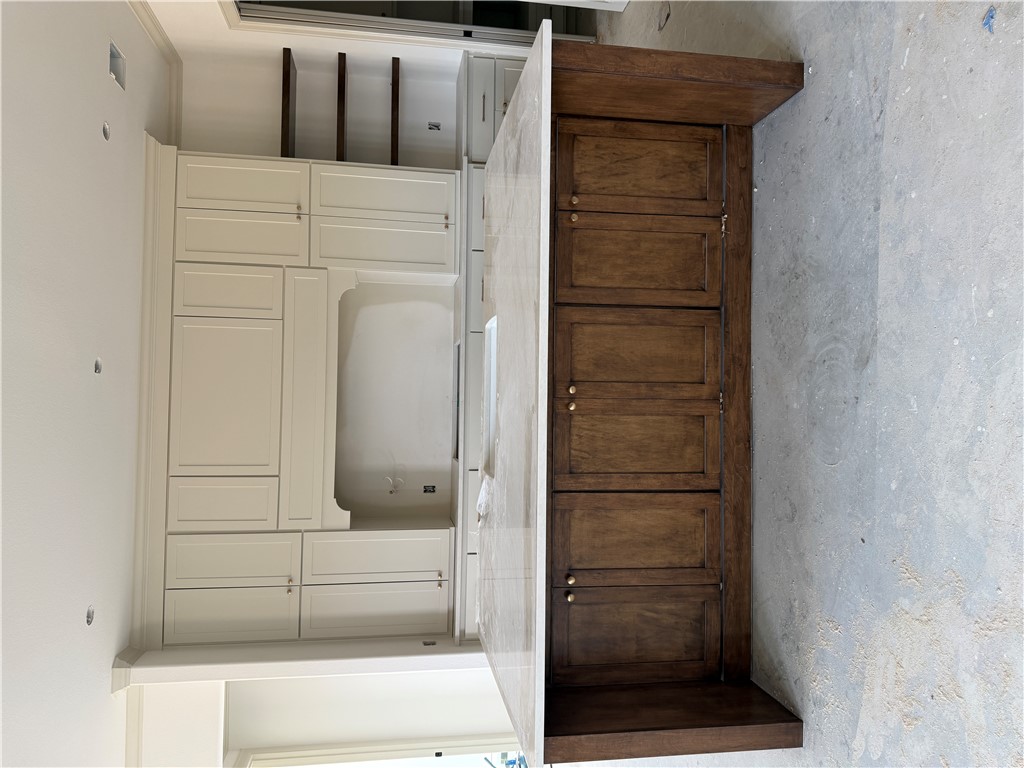 5107 Greenstone Way Bryan, TX 77802 - Photo 7 of 22 a kitchen with cabinets and wooden cabinets