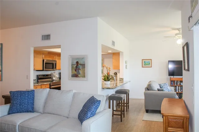 a kitchen with stainless steel appliances kitchen island granite countertop a stove a sink and a granite counter tops