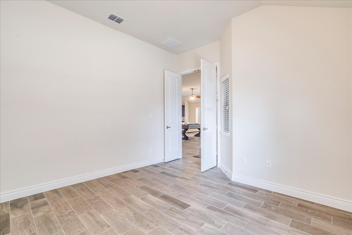 124 Compass Lane Kyle, TX 78640 - Photo 28 of 38 a view of a room with wooden floor