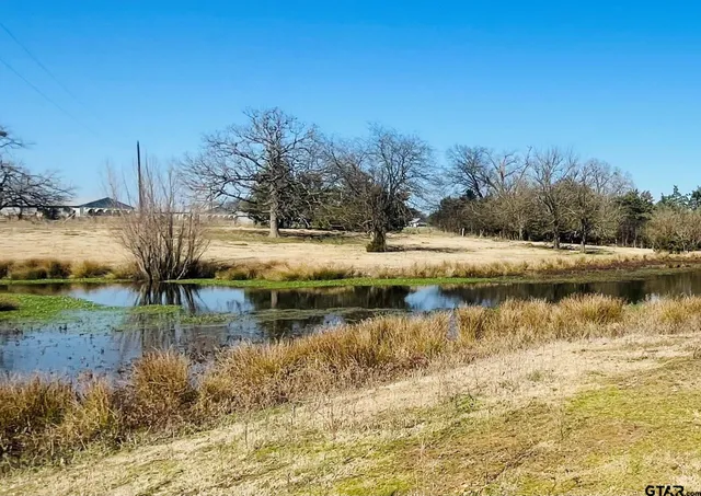 a view of a house with swimming pool and sitting area