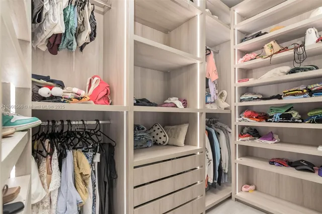 a bathroom with a tub sink and glass door shower