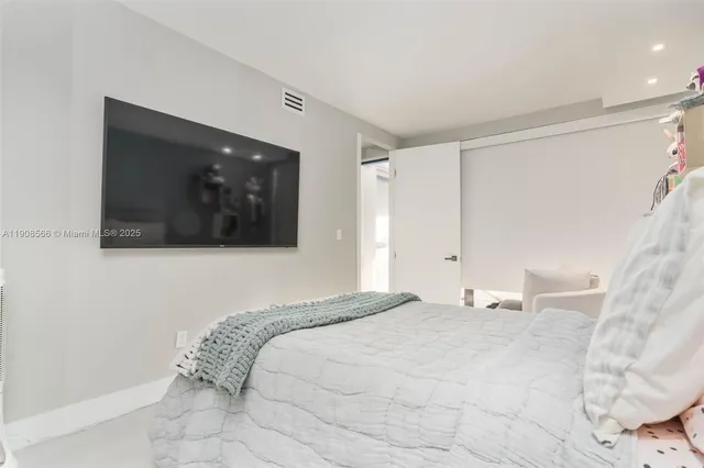 a bathroom with a double vanity sink toilet mirror and shower