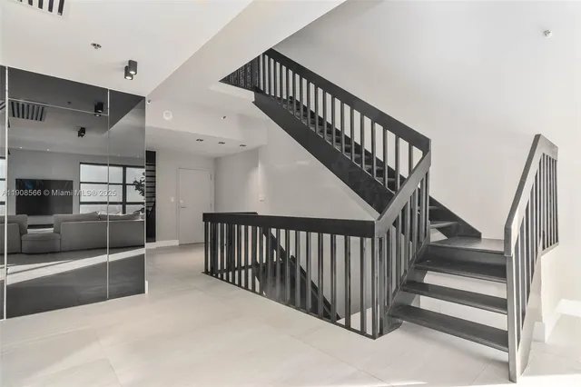 a view of a livingroom with furniture and staircase