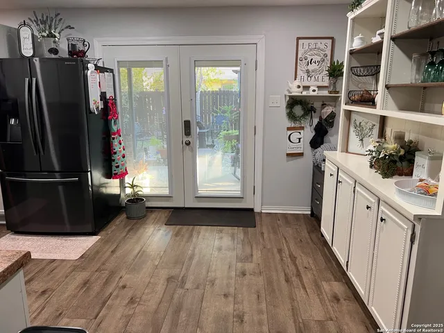 a view of a walk in closet with clothes and shoes