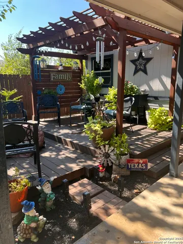 a view of a patio with table and chairs potted plants