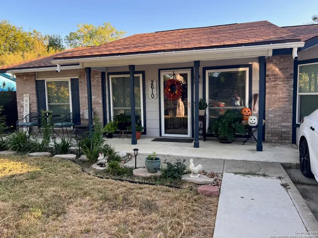 front view of a brick house with a small yard