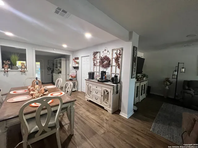 a view of a dining room with furniture window and wooden floor