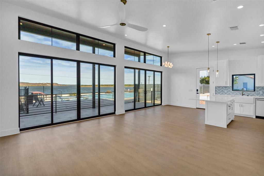 1782 Fm 2951, Unit 28 Graford, TX 76449 - Photo 13 of 30 a view of a big room with windows and chandelier