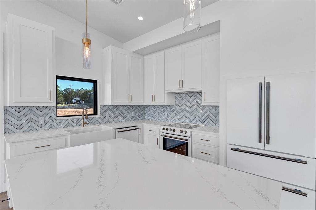 1782 Fm 2951, Unit 28 Graford, TX 76449 - Photo 14 of 30 a kitchen with stainless steel appliances granite countertop a stove a sink and a microwave