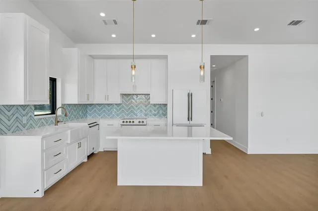 a kitchen with a sink and cabinets
