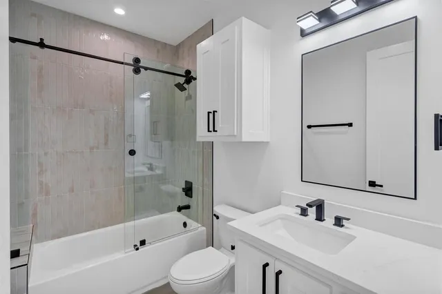 a view of a room with a window and a ceiling fan