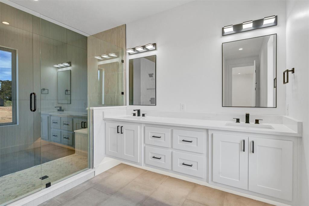 1782 Fm 2951, Unit 28 Graford, TX 76449 - Photo 24 of 30 a bathroom with double sink and a mirror