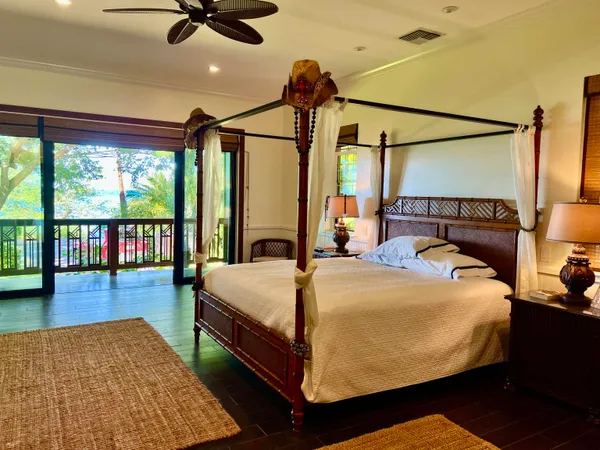 a bed sitting in a bedroom next to a large window