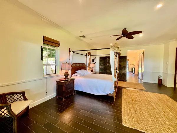 a bedroom with furniture and wooden floor