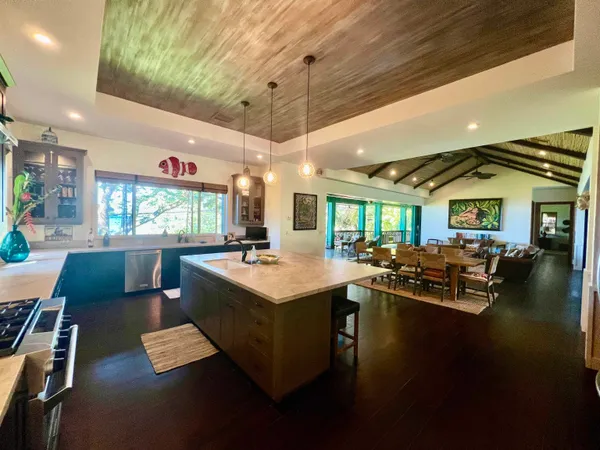 a large white kitchen with a large window