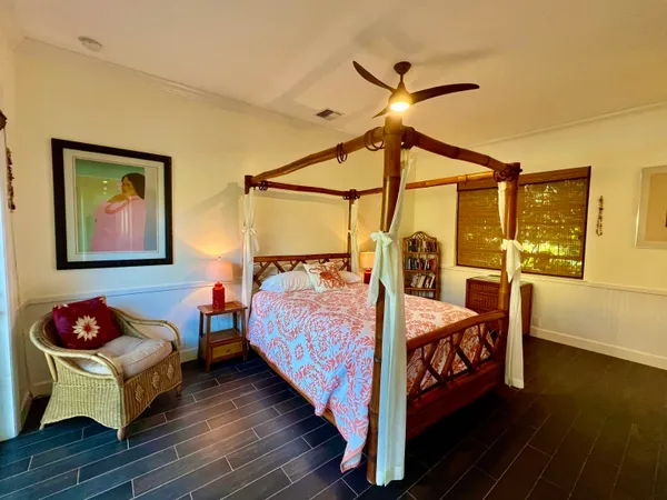 a bed sitting in a bedroom next to a window