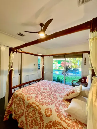 a bed sitting in a bedroom next to a window